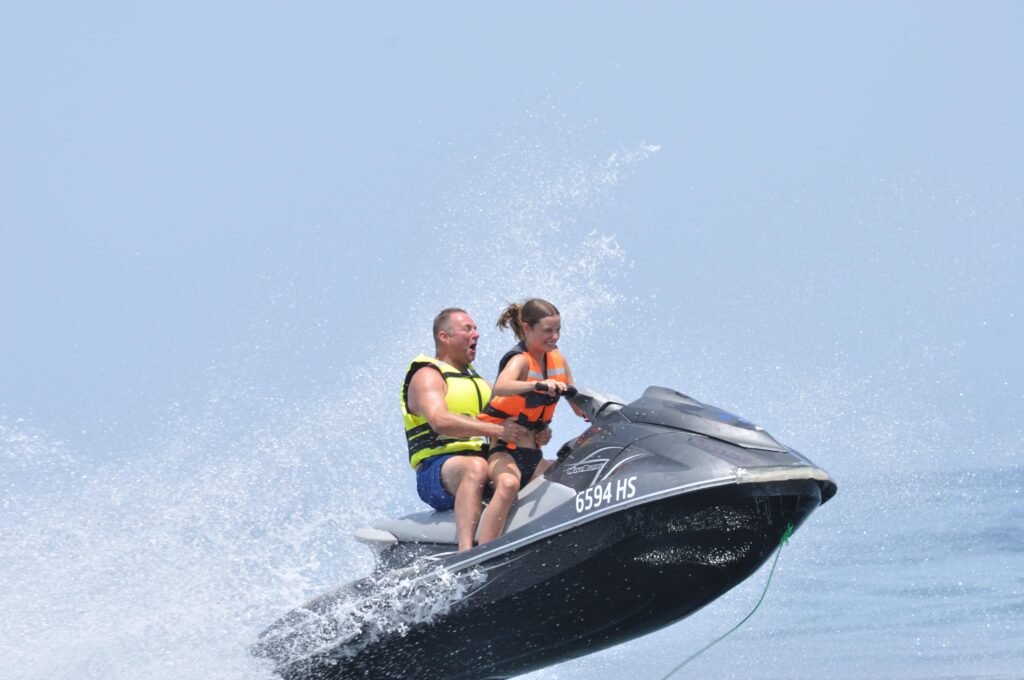 Famille de touristes s'amusant sur un jet ski au bord des plages de Djerba